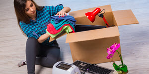 woman unpacking from a big moving box