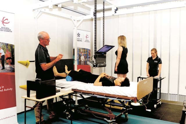 Professor Gordon Waddington (left) and Honours student Ashleigh Marchant (right) work with research volunteers on their proprioception study, performing a series of exercises standing and lying down. Photo: Vanessa Lam